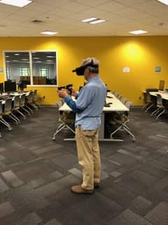 Pi member Roy Wagner tries on an Oculus VR headset, using a touch controller to manipulate objects in virtual space.